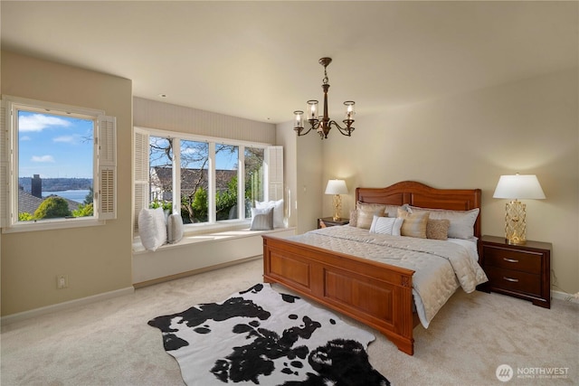 bedroom with baseboards, light colored carpet, and a chandelier