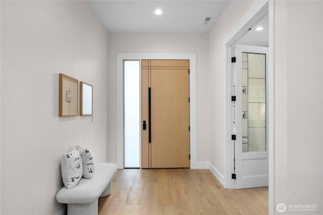 foyer with recessed lighting, baseboards, visible vents, and light wood finished floors