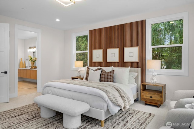 carpeted bedroom with recessed lighting and ensuite bathroom