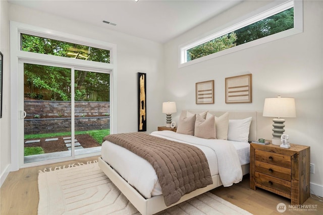 bedroom featuring visible vents and wood finished floors