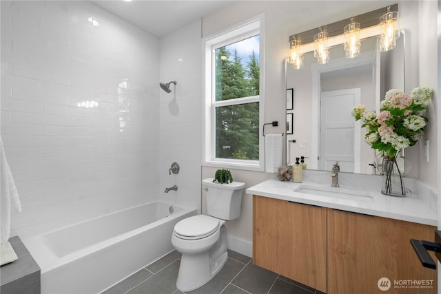 bathroom featuring vanity, tile patterned flooring, shower / washtub combination, toilet, and a chandelier