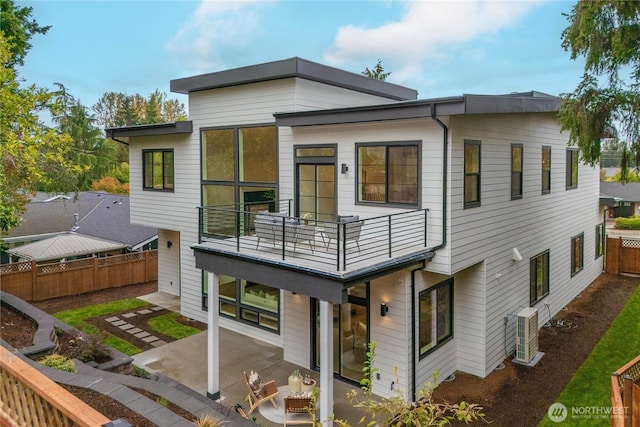 back of house with a patio, a balcony, and fence