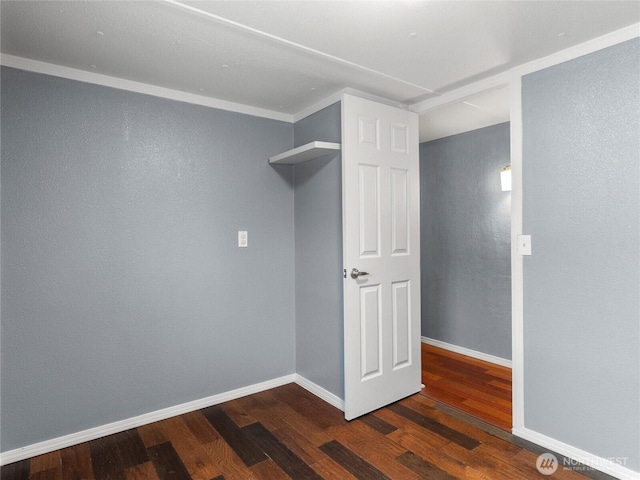 interior space with baseboards and wood finished floors