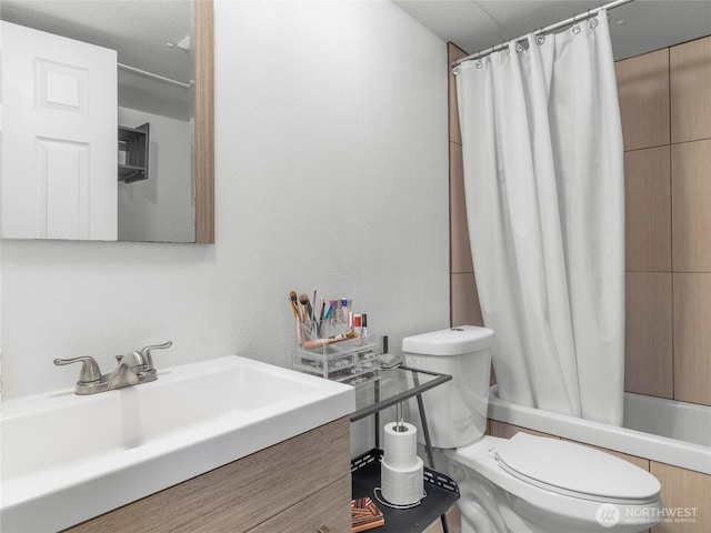 full bathroom featuring vanity, toilet, and shower / bathtub combination with curtain