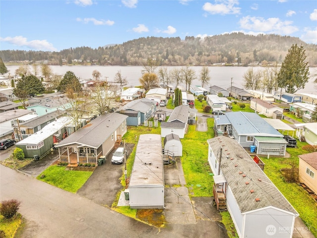 bird's eye view featuring a residential view, a water view, and a forest view