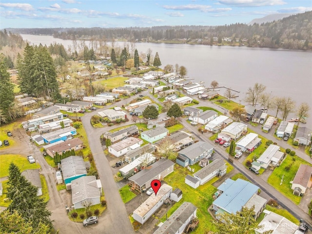 birds eye view of property with a water view and a residential view