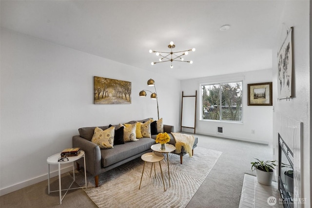 carpeted living area with a chandelier, baseboards, visible vents, and a fireplace with flush hearth