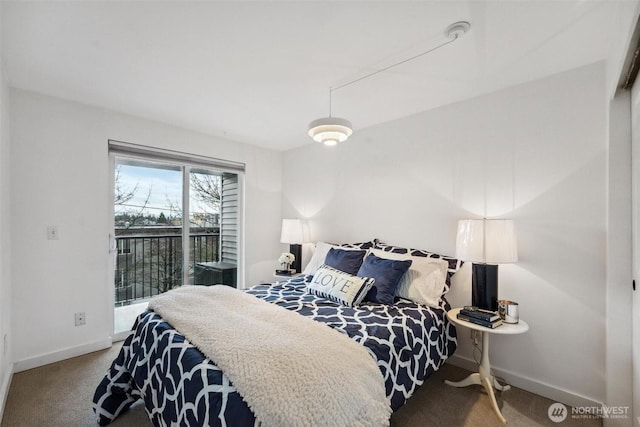 carpeted bedroom featuring baseboards and access to exterior