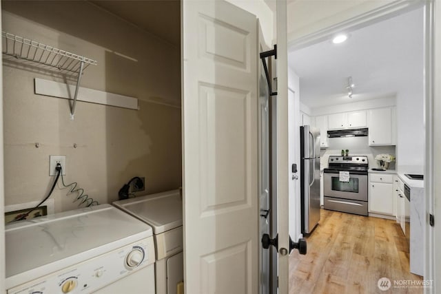 laundry room with recessed lighting, laundry area, light wood-style flooring, and separate washer and dryer