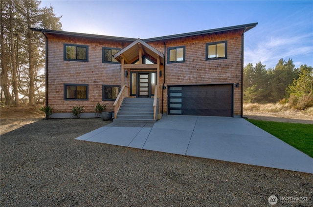 view of front of house with a garage and concrete driveway