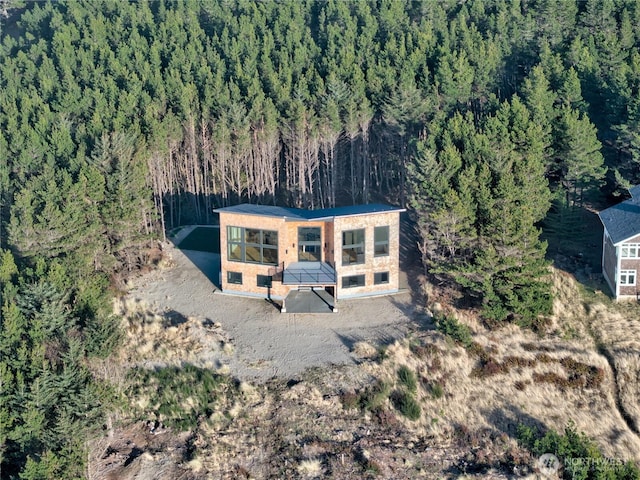 birds eye view of property with a forest view