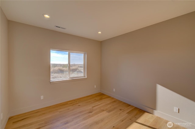 spare room with recessed lighting, light wood-style flooring, and baseboards