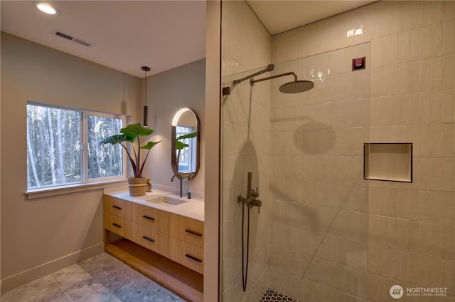 bathroom with recessed lighting, visible vents, vanity, baseboards, and walk in shower