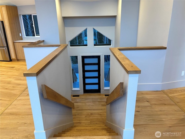 stairs with baseboards and wood finished floors