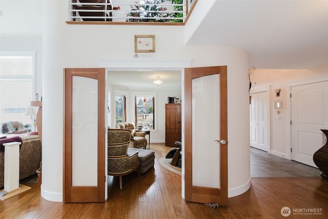 hallway featuring baseboards and wood finished floors