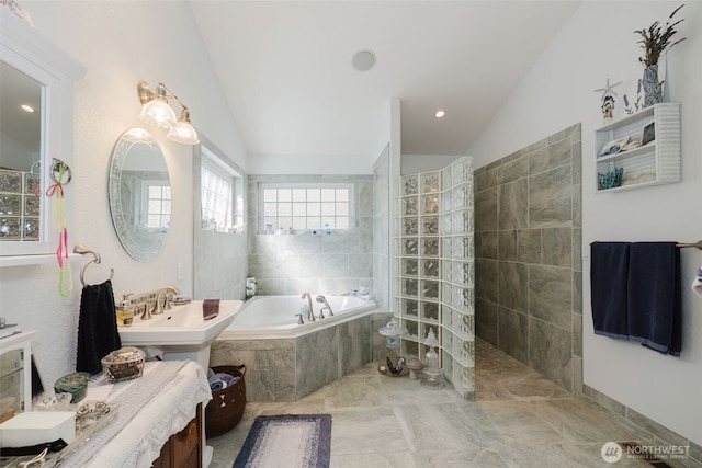 full bathroom featuring vaulted ceiling, a bath, and a walk in shower