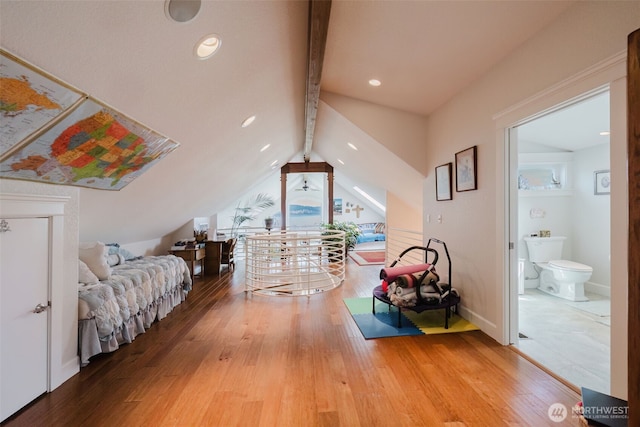 bedroom with vaulted ceiling with beams, ensuite bath, baseboards, and wood finished floors