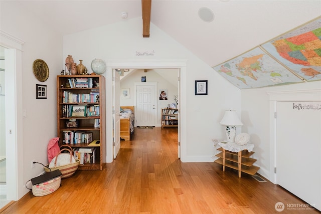 hallway with lofted ceiling with beams and light wood-type flooring