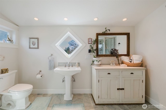 bathroom with toilet, baseboards, and recessed lighting