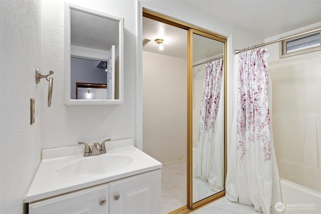 bathroom with marble finish floor and vanity