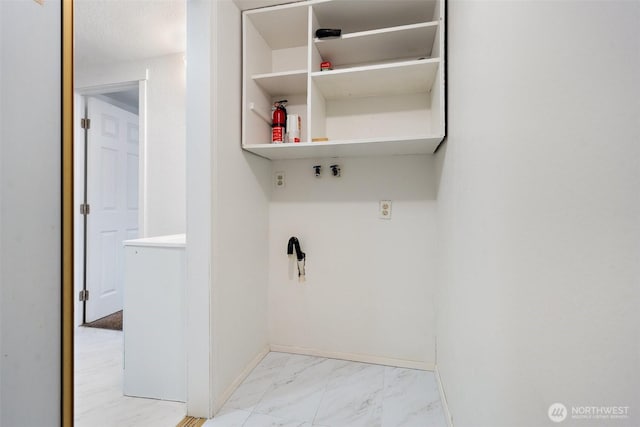 laundry room with marble finish floor and baseboards