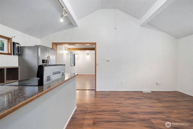 kitchen featuring lofted ceiling, dark wood-style flooring, baseboards, and stainless steel fridge with ice dispenser