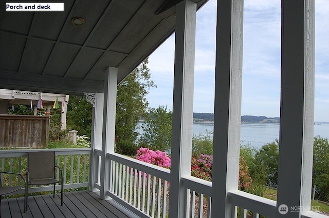 wooden terrace featuring a water view