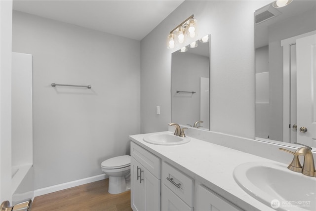 full bath with visible vents, a sink, toilet, and wood finished floors