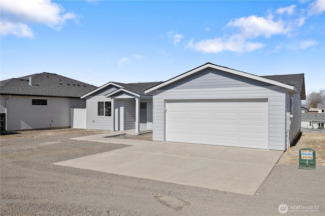 ranch-style home with an attached garage and concrete driveway