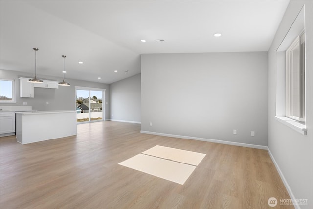 unfurnished living room with light wood-style floors, recessed lighting, and baseboards