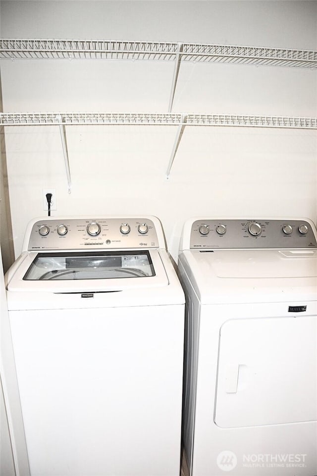 laundry area featuring separate washer and dryer and laundry area