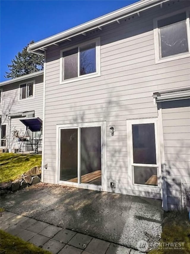 rear view of property featuring a patio area