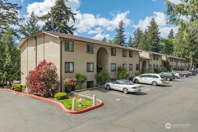 view of building exterior featuring uncovered parking