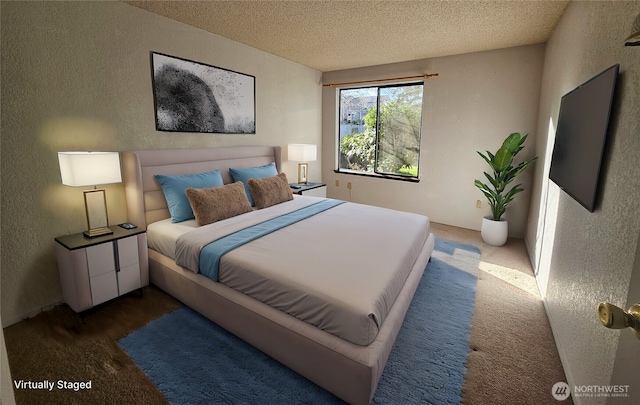 bedroom with a textured ceiling and a textured wall