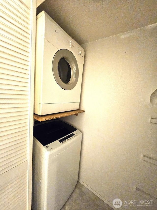 laundry room with stacked washer / dryer