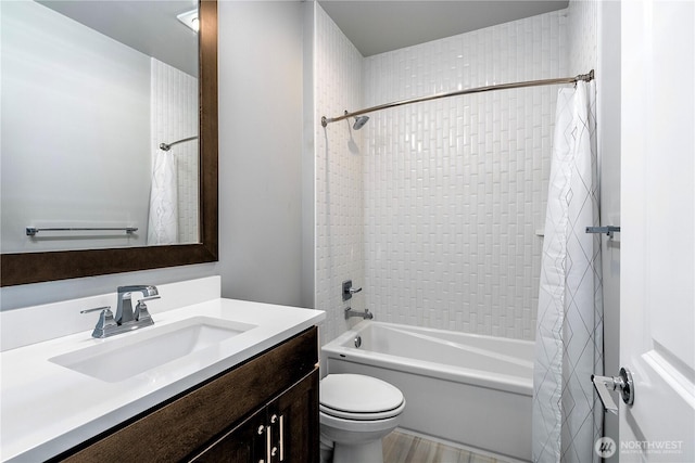 bathroom with shower / bath combo, vanity, and toilet