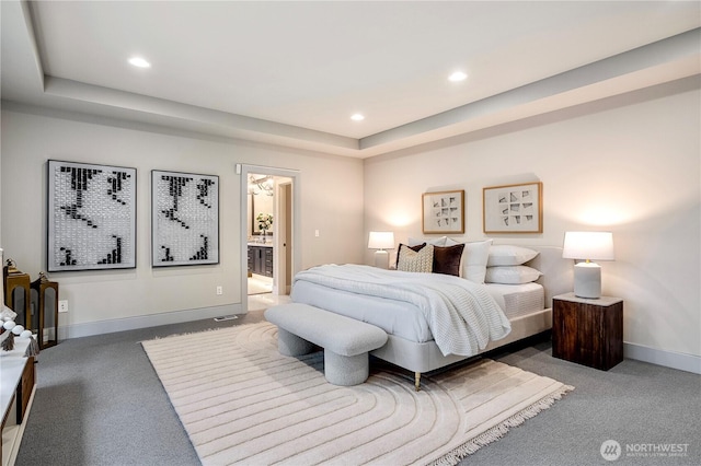 bedroom featuring recessed lighting, a tray ceiling, and baseboards