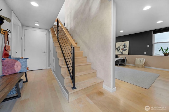 staircase featuring recessed lighting, baseboards, and wood finished floors