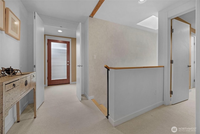 corridor featuring recessed lighting, baseboards, and light carpet