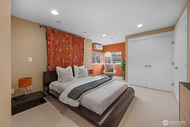 bedroom with light carpet, recessed lighting, a wall mounted air conditioner, and a closet