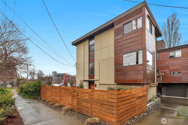 view of side of home featuring a fenced front yard