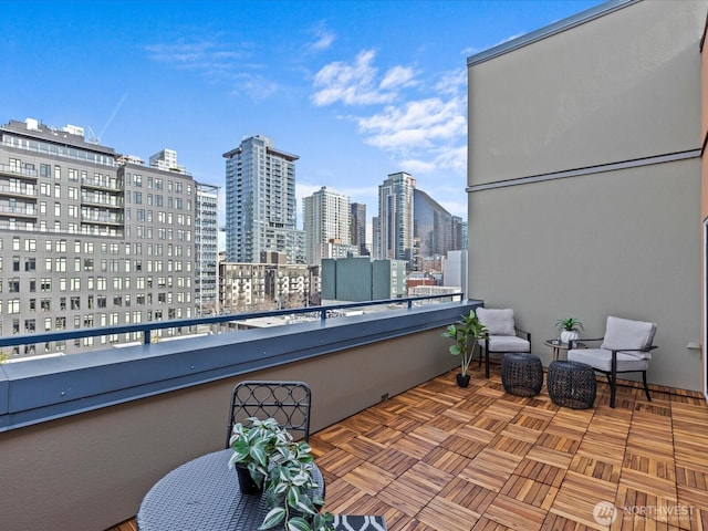 view of patio / terrace featuring a balcony and a city view