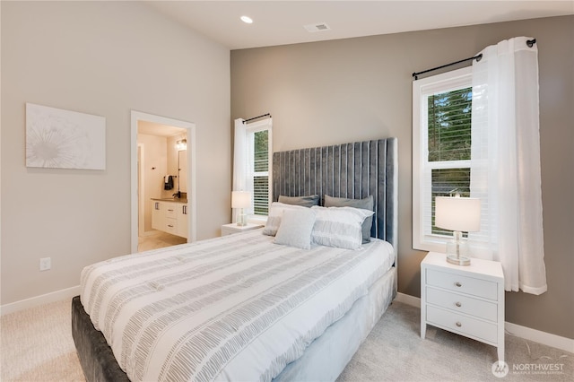 bedroom featuring light carpet, multiple windows, and baseboards