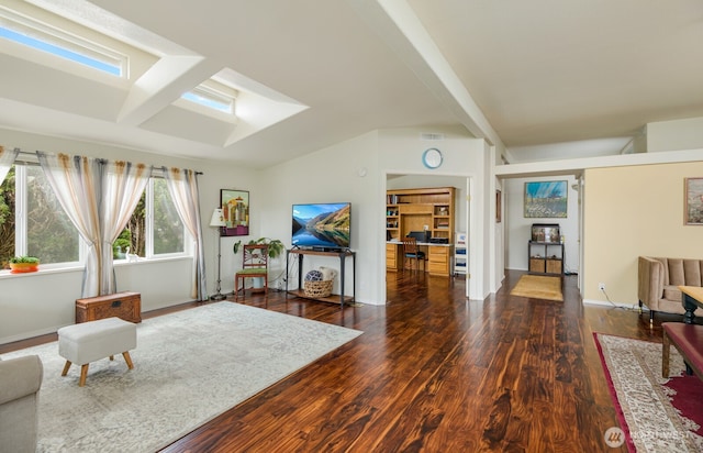 living room featuring vaulted ceiling, visible vents, baseboards, and wood finished floors