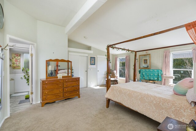 carpeted bedroom featuring lofted ceiling with beams