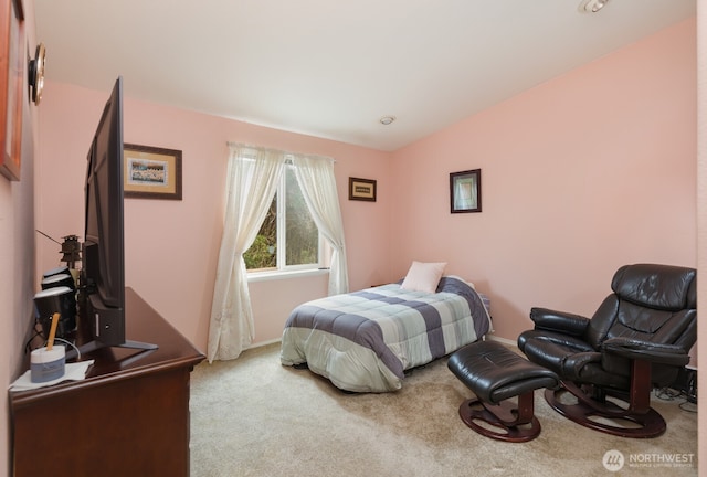 carpeted bedroom featuring baseboards and vaulted ceiling