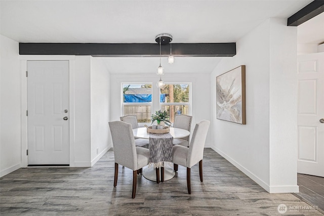 dining area with beamed ceiling, wood finished floors, and baseboards