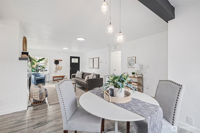 dining room featuring wood finished floors and baseboards