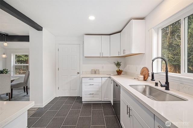 kitchen with recessed lighting, a sink, baseboards, white cabinets, and pendant lighting