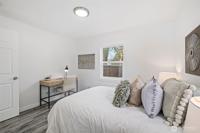 bedroom featuring baseboards and wood finished floors